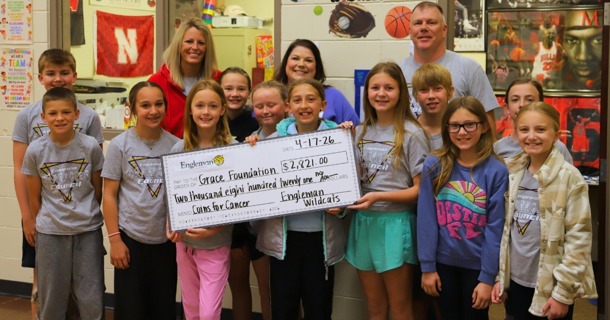 Engleman Student Character Council, Mrs. Nelson, and Mr. Caspar smile with Sarah Koch presenting her with the donation check for GCF