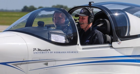 UNK Chancellor Neal Schnoor and assistant chief flight instructor Masahiro Suzuki land one of the Tecnam planes at Kearney Regional Airport during Thursday’s ribbon-cutting ceremony celebrating the new Loper Flight Academy. (Photo by Erika Pritchard, UNK Communications)