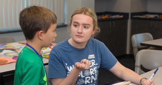Laura Walsh works with a student during the Loper Launch Speech Academy in June. Walsh lives in Juneau, Alaska, but she’s earning a master’s degree in speech-language pathology through UNK. (Photo by Erika Pritchard, UNK Communications)