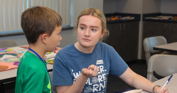 Laura Walsh works with a student during the Loper Launch Speech Academy in June. Walsh lives in Juneau, Alaska, but she’s earning a master’s degree in speech-language pathology through UNK. (Photo by Erika Pritchard, UNK Communications)   