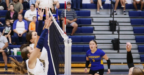 Grand Island Lutheran's Lauren Smith and Ellie Keasling look to block a shot against Riverside Tuesday night at GILH. (Photo by Josh Salmon)